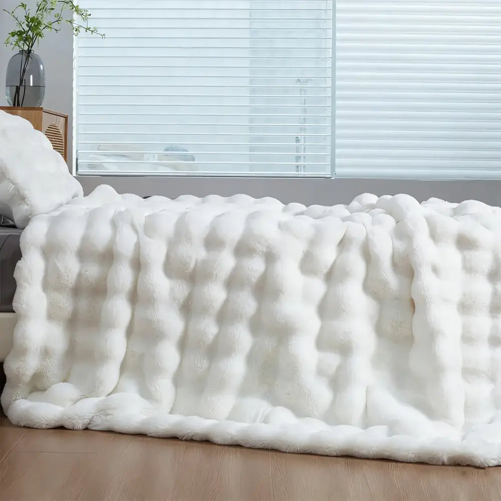 White plush faux rabbit throw blanket with soft fluffy texture for cozy warm comfort and thick faux fur feel