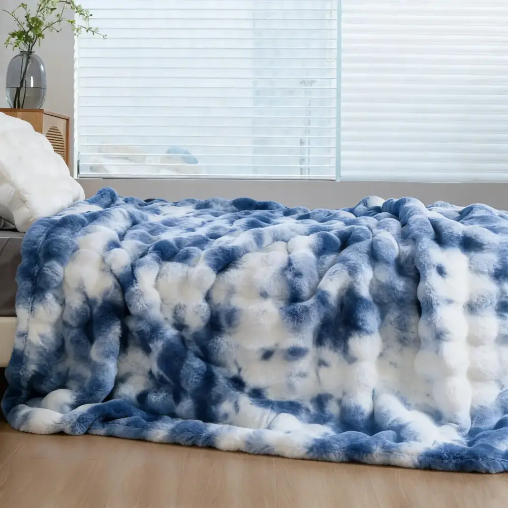 A plush faux rabbit tie-dye blue and white faux fur throw blanket soft cozy warm thick textured surface