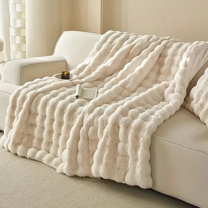 Cream-colored plush faux rabbit fur throw blanket with chunky knit pattern soft warm and cozy thick rabbit blanket