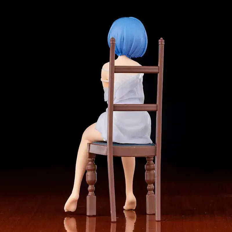 Blue-haired Rem anime figure in white dress seated on brown wooden chair ReZero chair pvc figure collectible