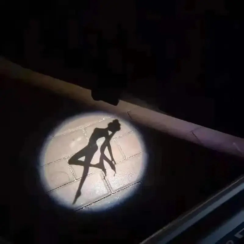 A sailor moon anime projector car door light projecting a dancer silhouette onto tiled ground in white led