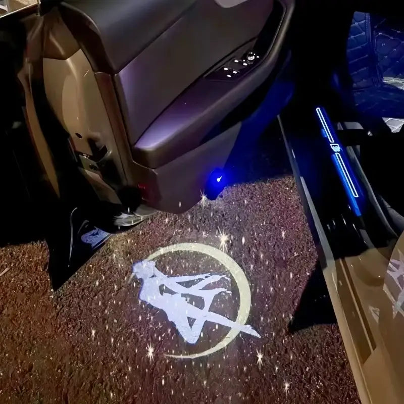 A glowing white sailor moon projector lamp with sparkling stars cast onto a textured brown car floor mat