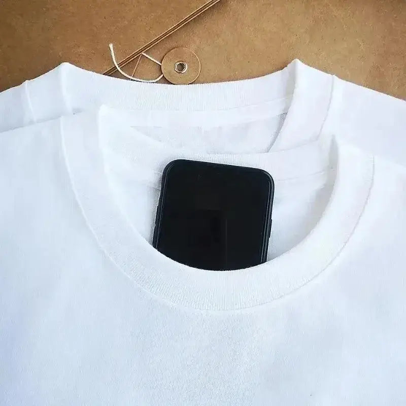 White cotton short sleeve sailor moon retro graphic tee with a black smartphone tucked into the neckline
