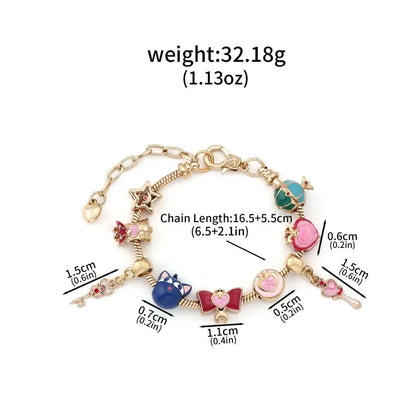 Gold-toned enamel keychain bracelet with colorful charms including blue cat pink bow and green gemstone for cosplay jewelry