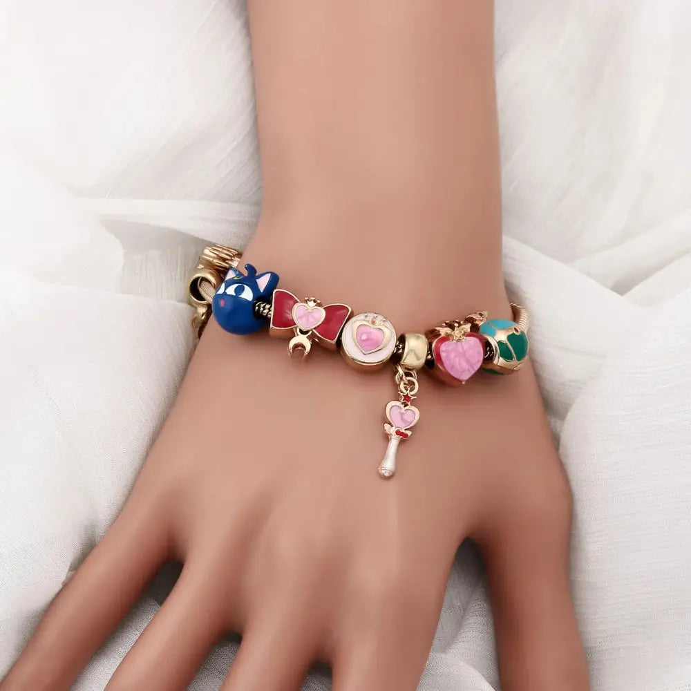 Colorful sailormoon usagi enamel keychain with gold-toned chain and assorted enamel charms including blue cat face and key charm