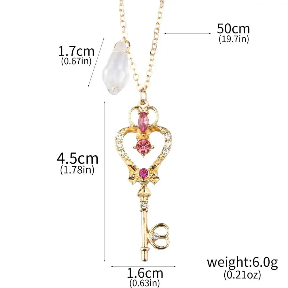 Gold-colored key-shaped pendant necklace with pink and clear crystals and heart motif for sailor moon enamel keychain cosplay