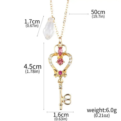 Gold-colored key-shaped pendant necklace with pink and clear crystals and heart motif for sailor moon enamel keychain cosplay
