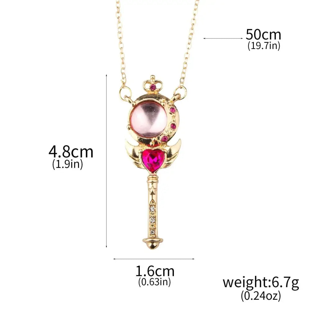 Gold-colored magical wand pendant with pink and red crystals on usagi enamel keychain for cosplay jewelry