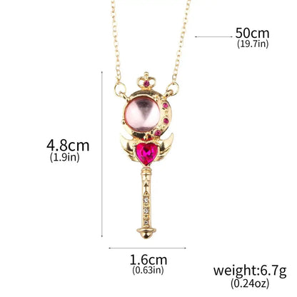 Gold-colored magical wand pendant with pink and red crystals on usagi enamel keychain for cosplay jewelry