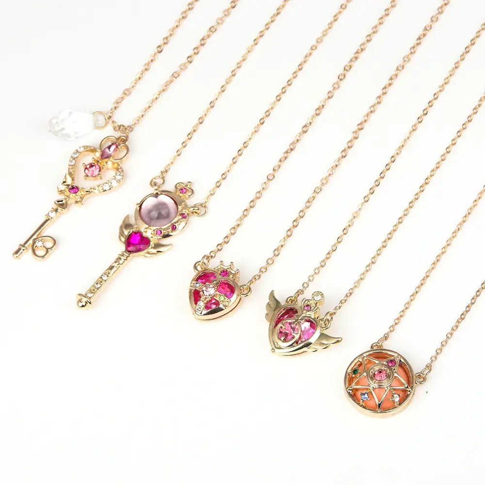 Gold-toned sailor moon tsukino necklace set with key and heart pendants featuring pink gemstones and clear crystals