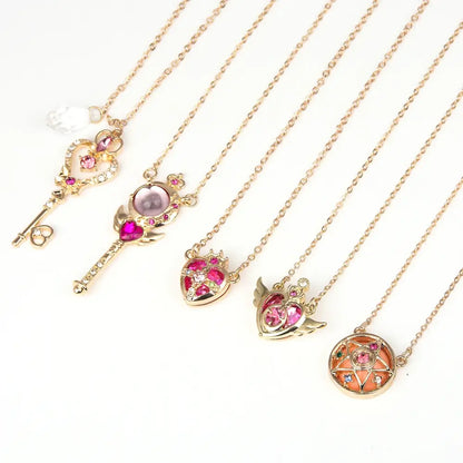 Gold-toned sailor moon tsukino necklace set with key and heart pendants featuring pink gemstones and clear crystals