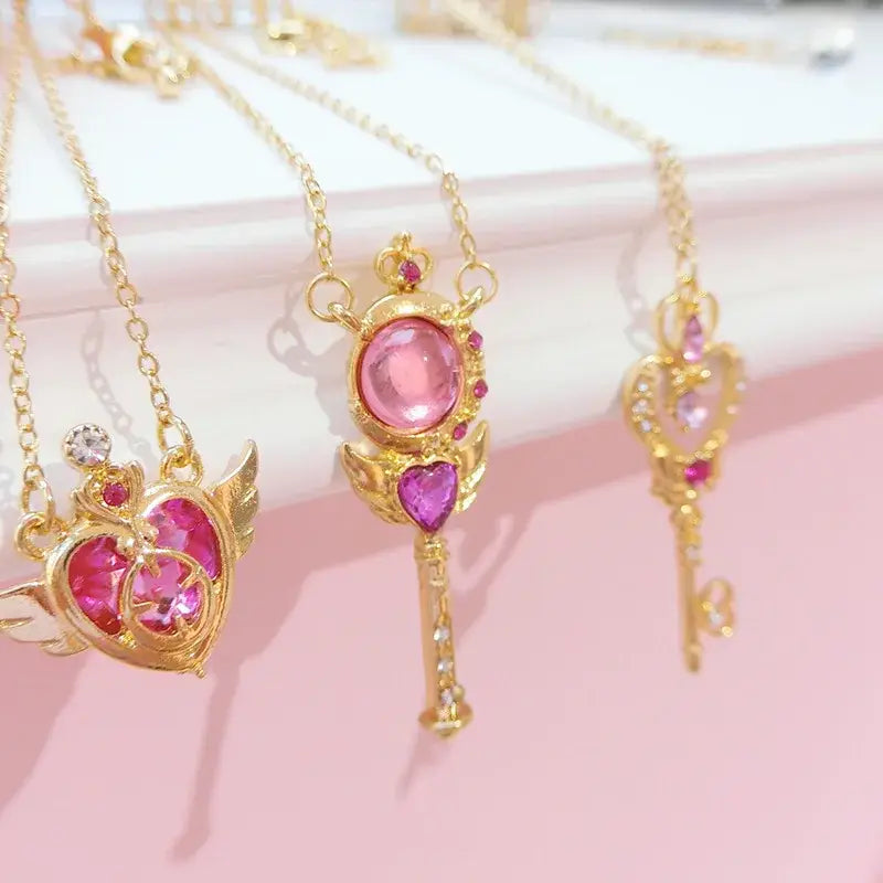 Golden key-shaped pendant necklace with pink gemstones and heart accents from sailor moon tsukino necklace set