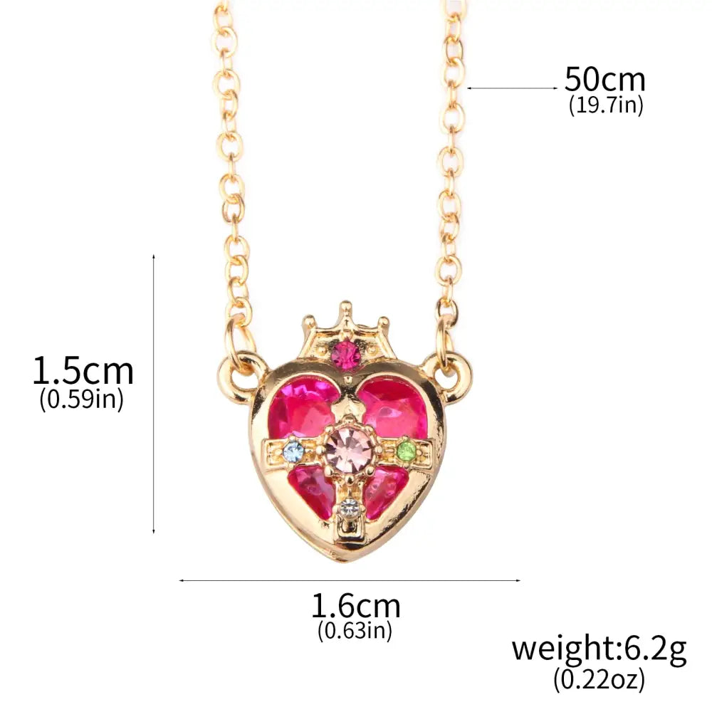 Gold-toned heart pendant necklace set with crown and pink gemstones from sailor moon tsukino enamel collection