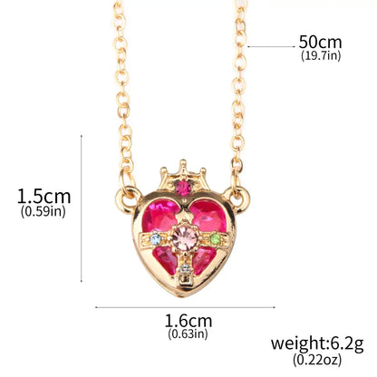 Gold-toned heart pendant necklace set with crown and pink gemstones from sailor moon tsukino enamel collection
