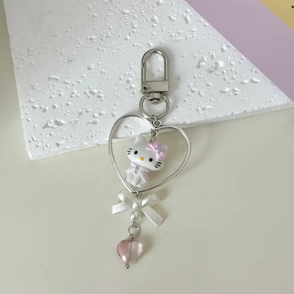 Silver heart-shaped acrylic phone chain keychain with white hello kitty figurine and pink accents by sanrio