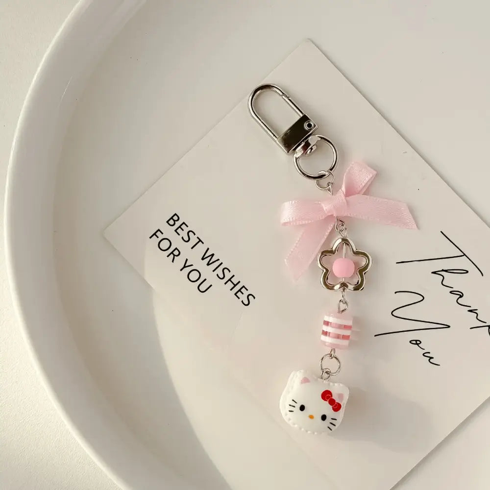 Pink Sanrio hello kitty acrylic phone chain keychain with silver clasp satin ribbon bow and layered charms