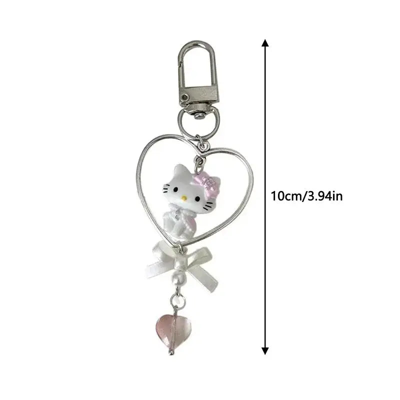 Sanrio hello kitty acrylic phone chain keychain with silver heart, white figurine, pink bow, pearl ribbon, and pink charm