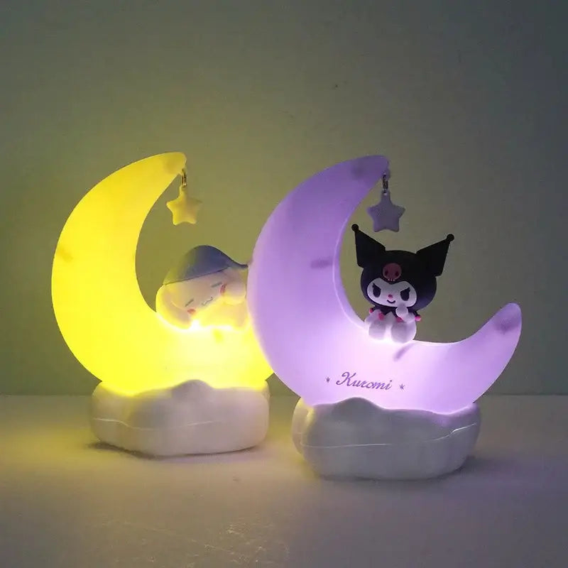 Two sanrio kuromi cinnamoroll crescent led night lights glowing yellow and purple with sleeping white and black characters