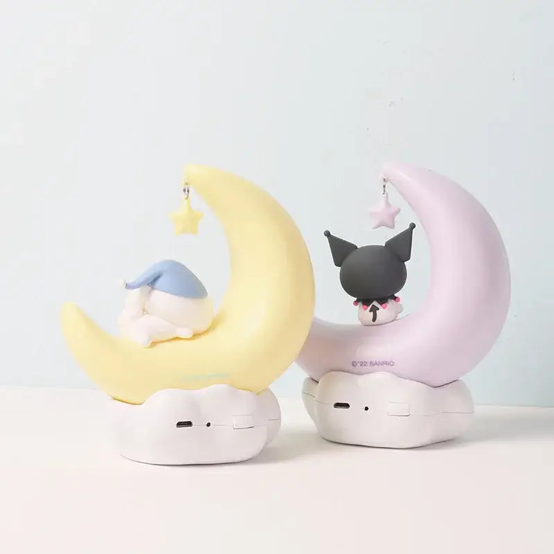 Two plush sanrio kuromi and cinnamoroll crescent night light figurines in yellow and pink with led star detail