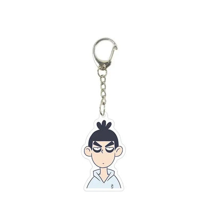 A clear acrylic killer seven keychain featuring a cartoon character with black hair and an angry expression