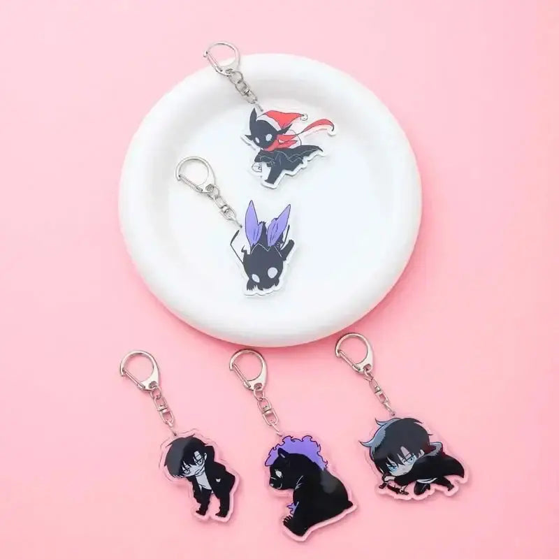Solo leveling sung jin-woo clear acrylic keychain featuring chibi anime characters in black purple and red with pink outlines