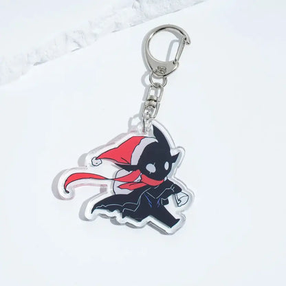 Clear acrylic solo leveling sung keychain with black bat wearing red santa hat and scarf attached to silver clasp