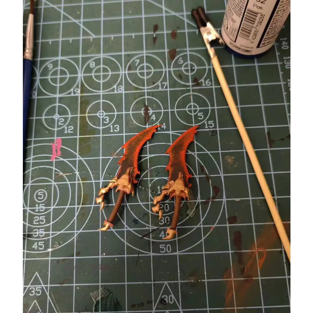 Two intricately painted orange and brown fantasy swords for solo leveling sung jin-woo 1/12 scale action figure