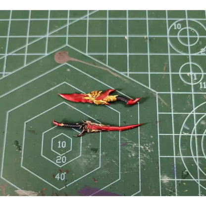 Two intricately painted miniature swords with red and gold details for solo leveling sung jin-woo articulated figure