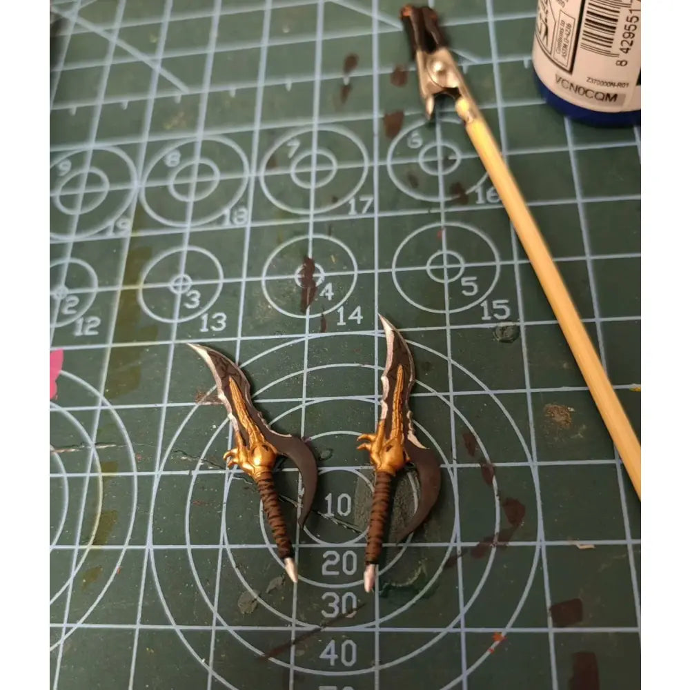 Two intricately painted golden and brown metallic miniature warhammers with claw grips for solo leveling sung jin-woo articulated figure