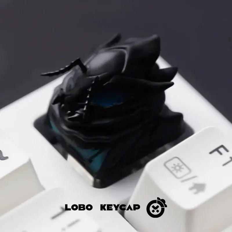 Black glossy resin solo leveling sung jin-woo esc keycap shaped like a beetle with teal accents on a white keyboard