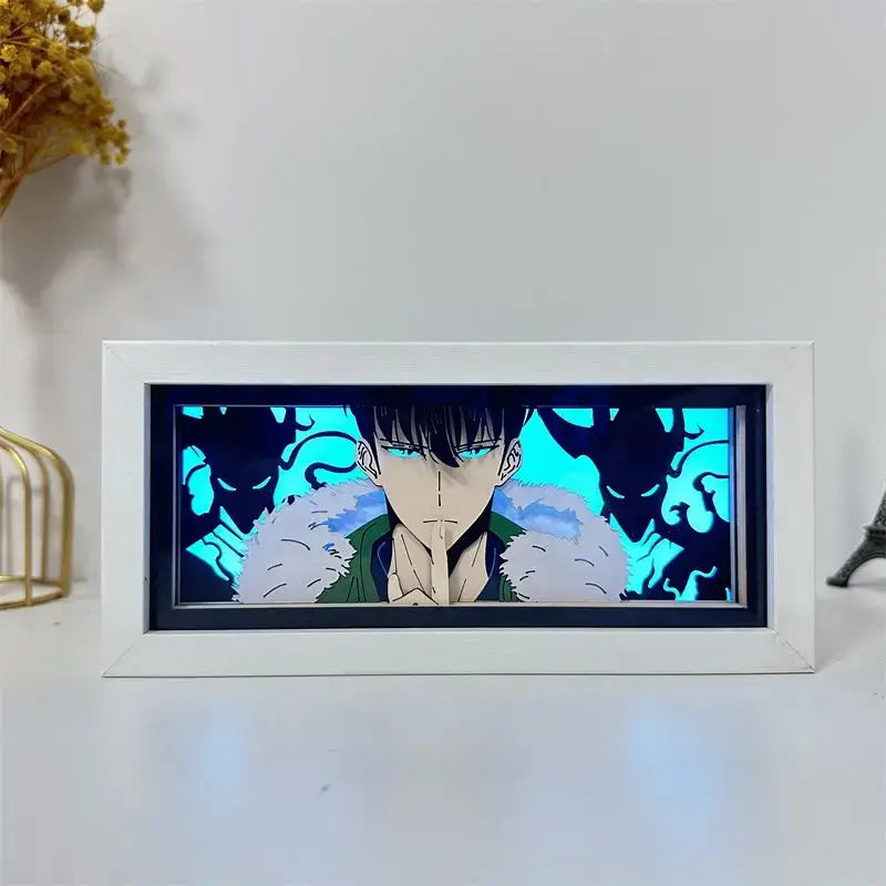 White-framed solo leveling sung jin-woo paper cut shadow box led lamp with glowing blue eyes and cyan background