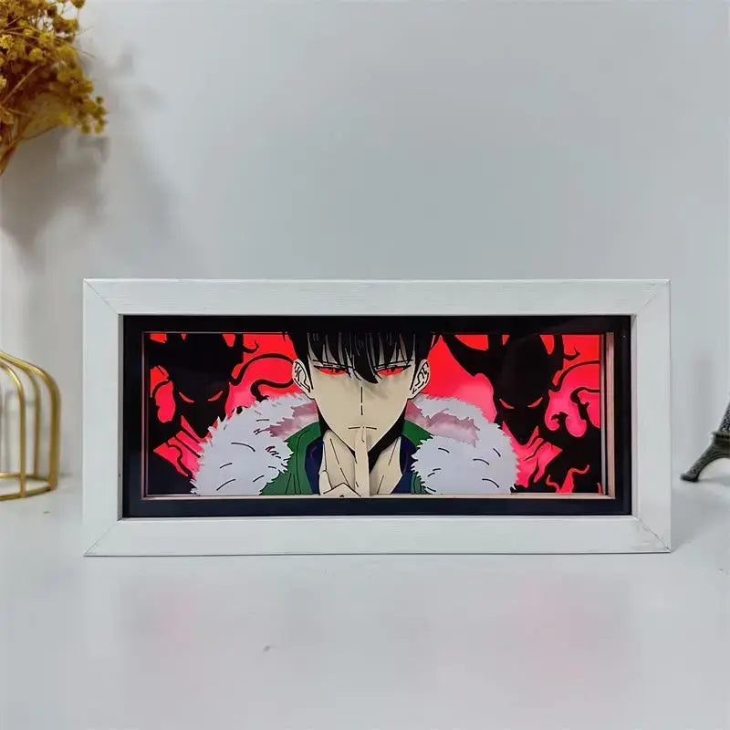 White-framed solo leveling paper cut shadow box led lamp featuring black-haired character with red eyes and green fur jacket