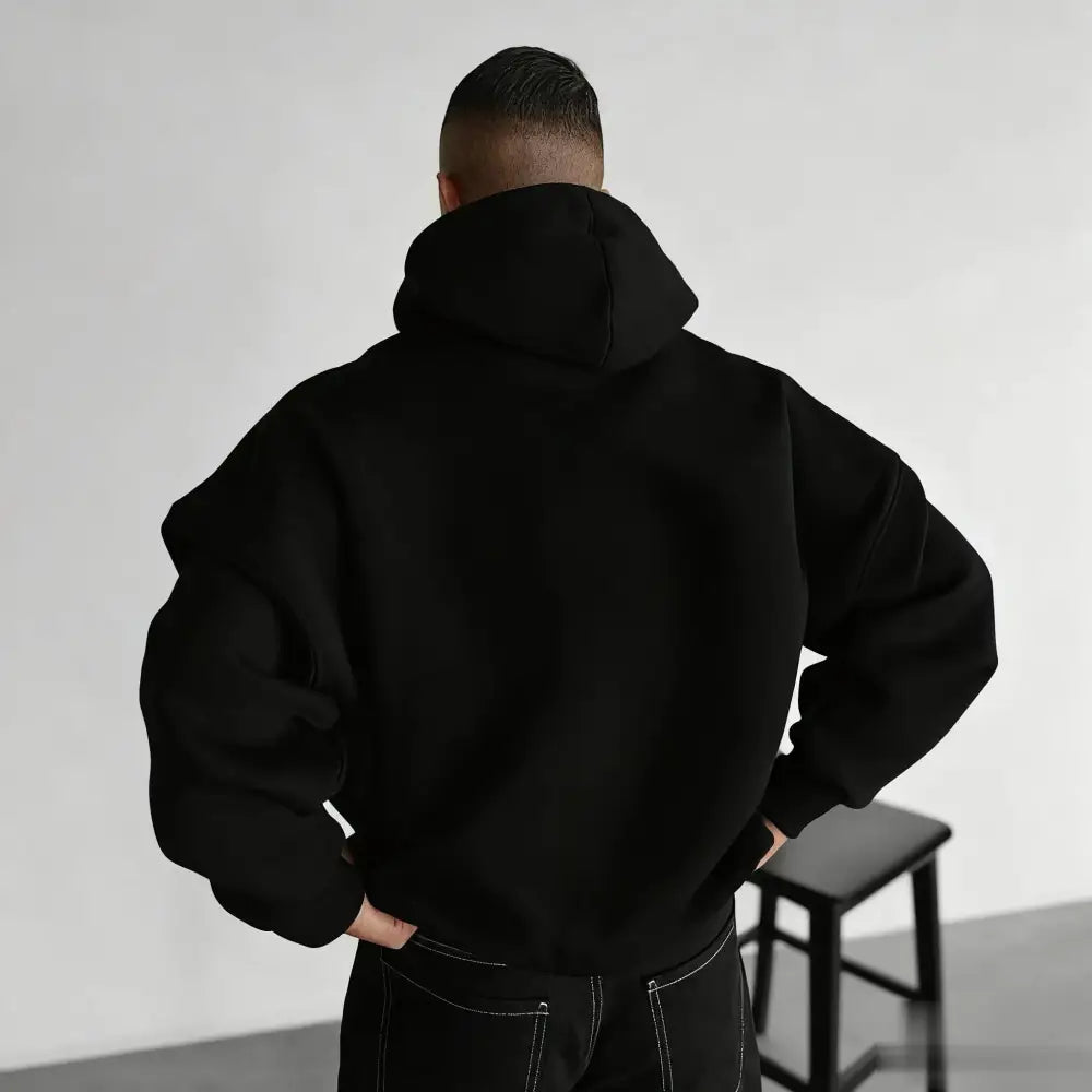 Black oversized solo leveling hoodie with relaxed fit and ribbed cuffs for unisex casual wear