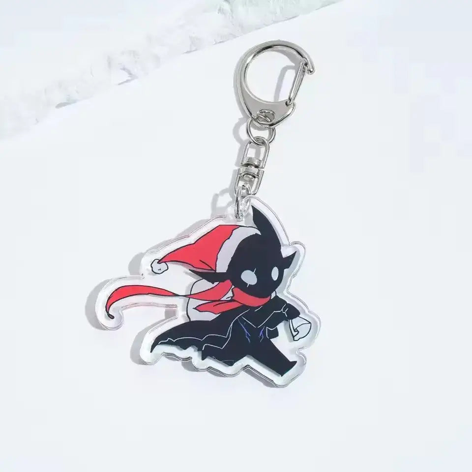 Clear acrylic solo leveling sung jinwoo acrylic keychain with black bat wearing red santa hat and scarf attached to silver clasp