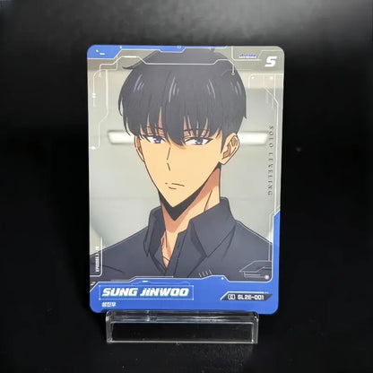 Blue-bordered solo leveling sung jinwoo trading card korean edition featuring him in dark uniform with sharp eyes