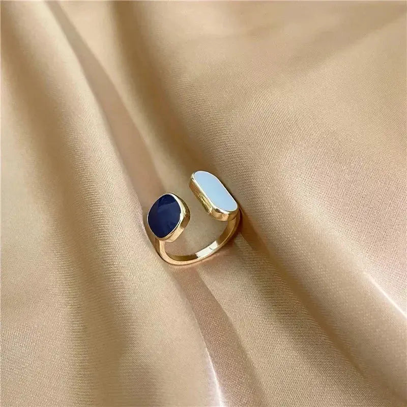 Gold-toned adjustable soul eater death the kid skull ring with navy blue oval stone and light blue rectangular accent