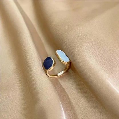 Gold-toned adjustable soul eater death the kid skull ring with navy blue oval stone and light blue rectangular accent