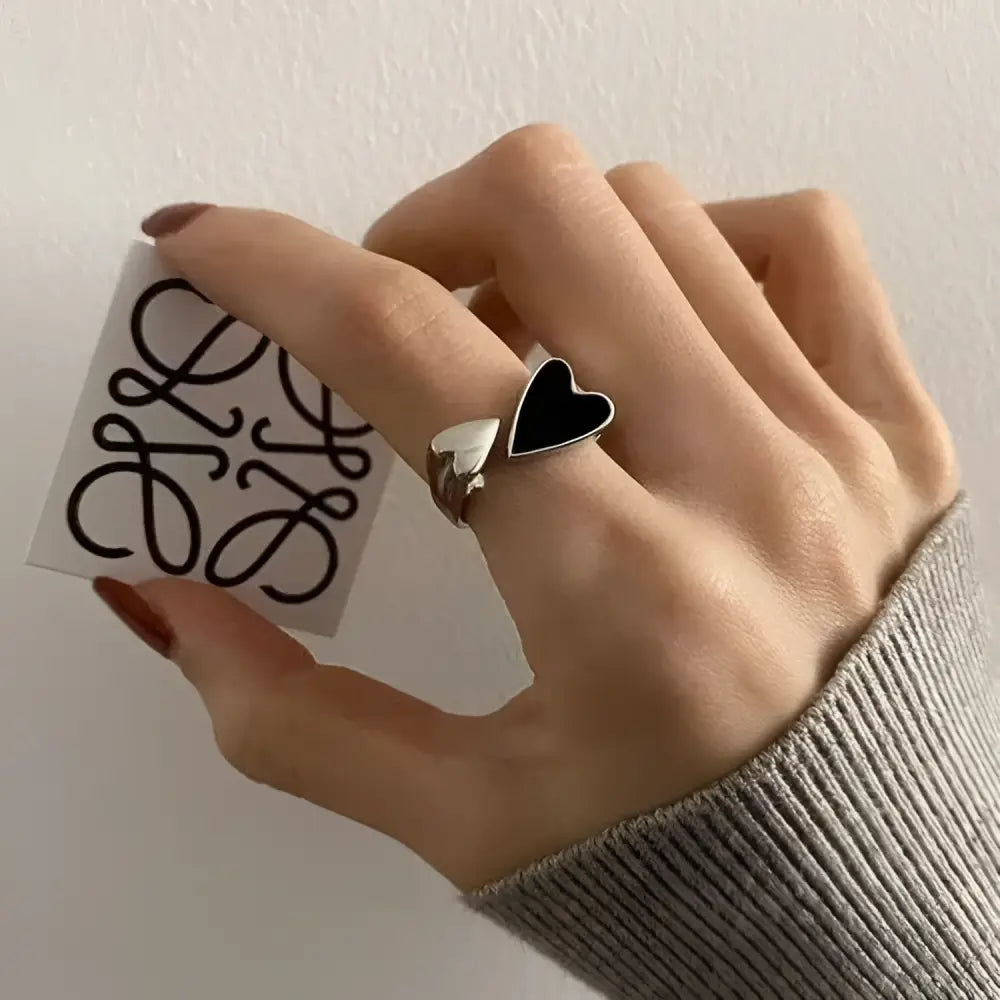 Silver heart-shaped soul eater kid skull ring with black inlay and adjustable metal sleek modern design