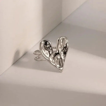 Silver adjustable metal soul eater kid skull ring with abstract heart shape and textured molten metal finish