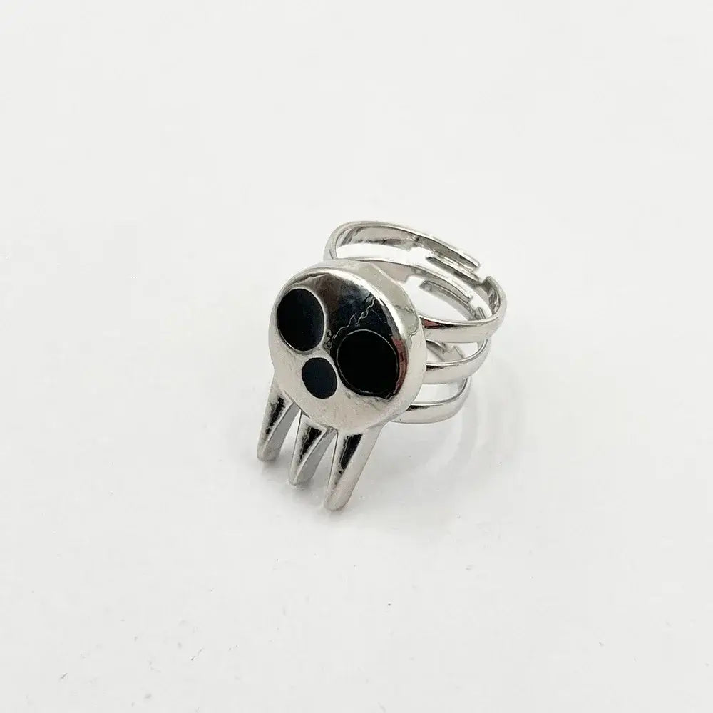 Silver soul eater kid skull ring with black inlaid eyes pointed teeth and adjustable multi-band metal band