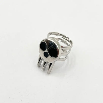 Silver soul eater kid skull ring with black inlaid eyes pointed teeth and adjustable multi-band metal band