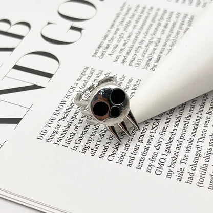 Silver soul eater kid skull ring with black inlaid eyes and sharp metallic spikes adjustable metal band