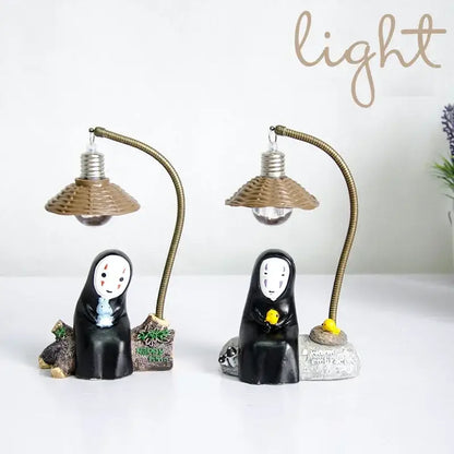 Black resin no-face led desk lamp with woven brown lampshade and flexible brass-colored gooseneck arm for eye protection