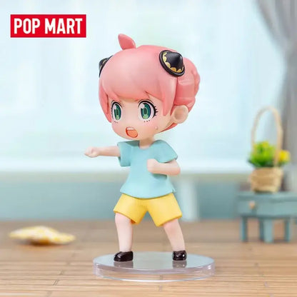 Spy x family anya blind box figure with pink hair green eyes and bat accessories in a desktop collectible design