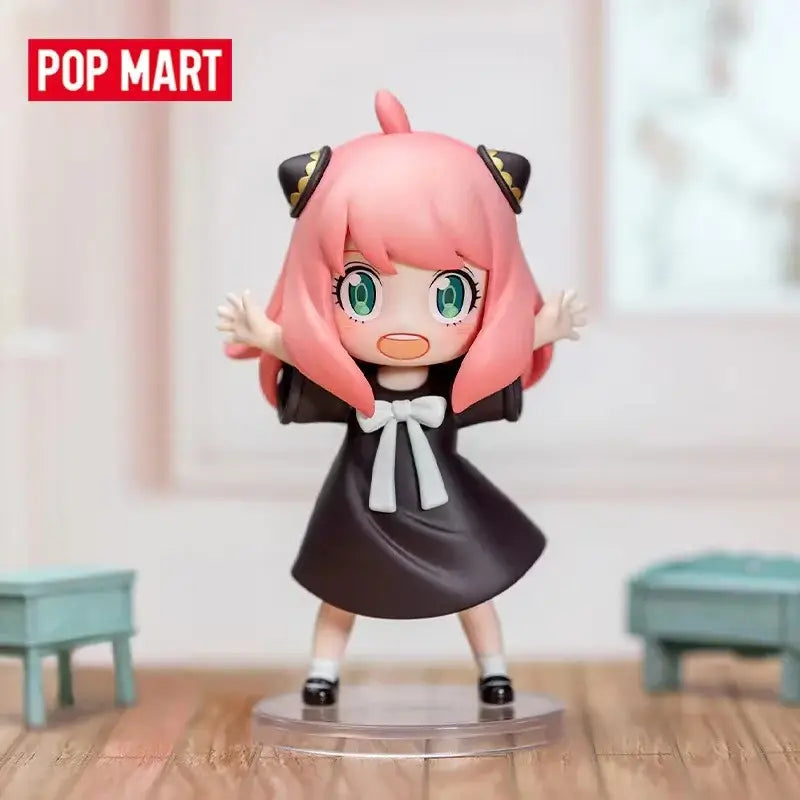 Spy x family anya blind box figure with pink hair green eyes black dress white bow and cat ears desktop collectible