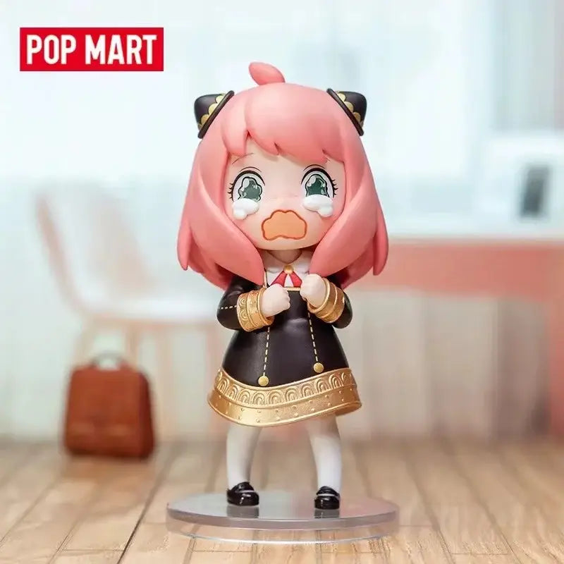 Pink-haired crying anime girl figurine with black and gold details from spy x family anya blind box collectible