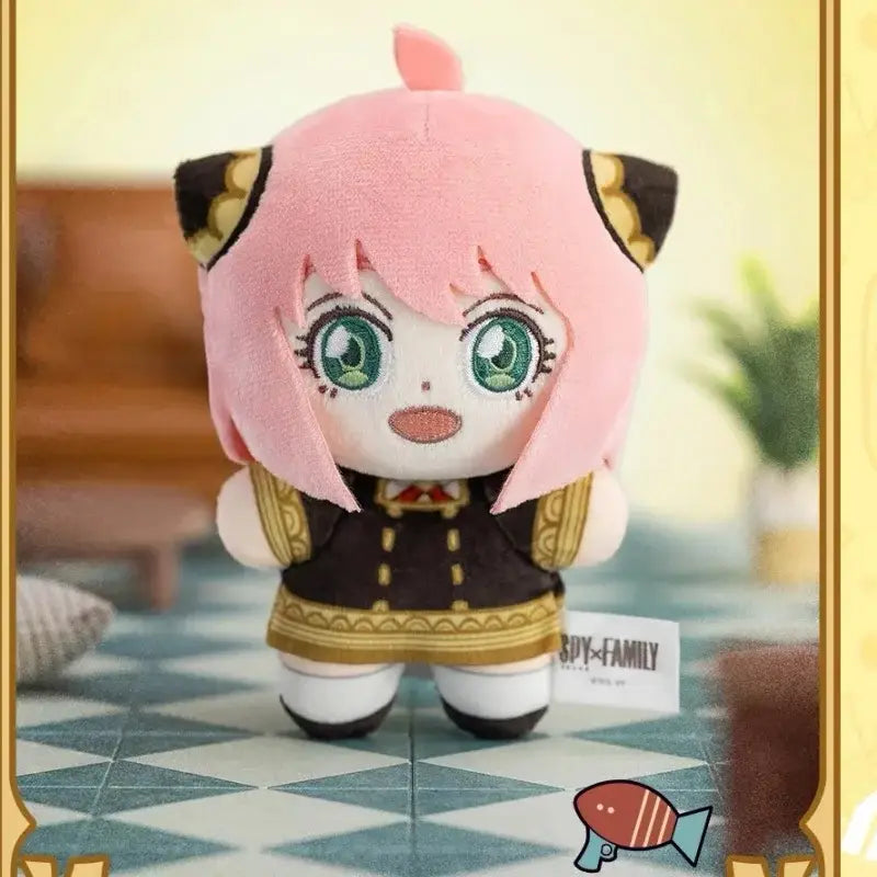 Pink plush spy x family anya blind box figure with green eyes black and gold outfit and cat ears for desktop display