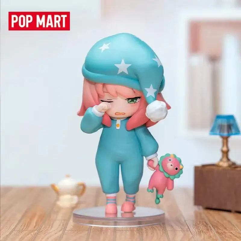 Spy x family anya blind box figure wearing a blue star-patterned sleep cap with white stars and fluffy pom-poms