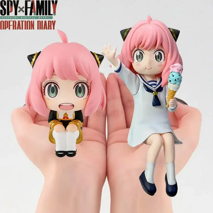 Two pink-haired spy x family anya forger pvc figures in black gold uniform with cat ears and white sailor dress holding ice cream