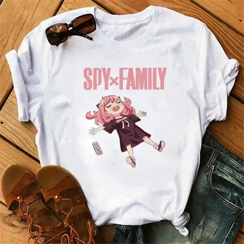 White cotton t-shirt featuring pink-haired anya forger from spy x family in mid-air with matching pink lettering